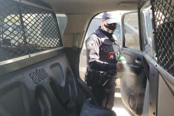 Hobbs police officer spraying cruiser with Biomist disinfectant
