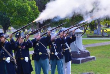 SUVCW members fire rifles in Civil War uniforms