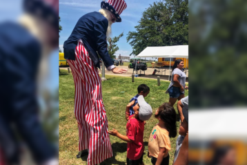 Uncle Sam with children. Stilts, blurred background.