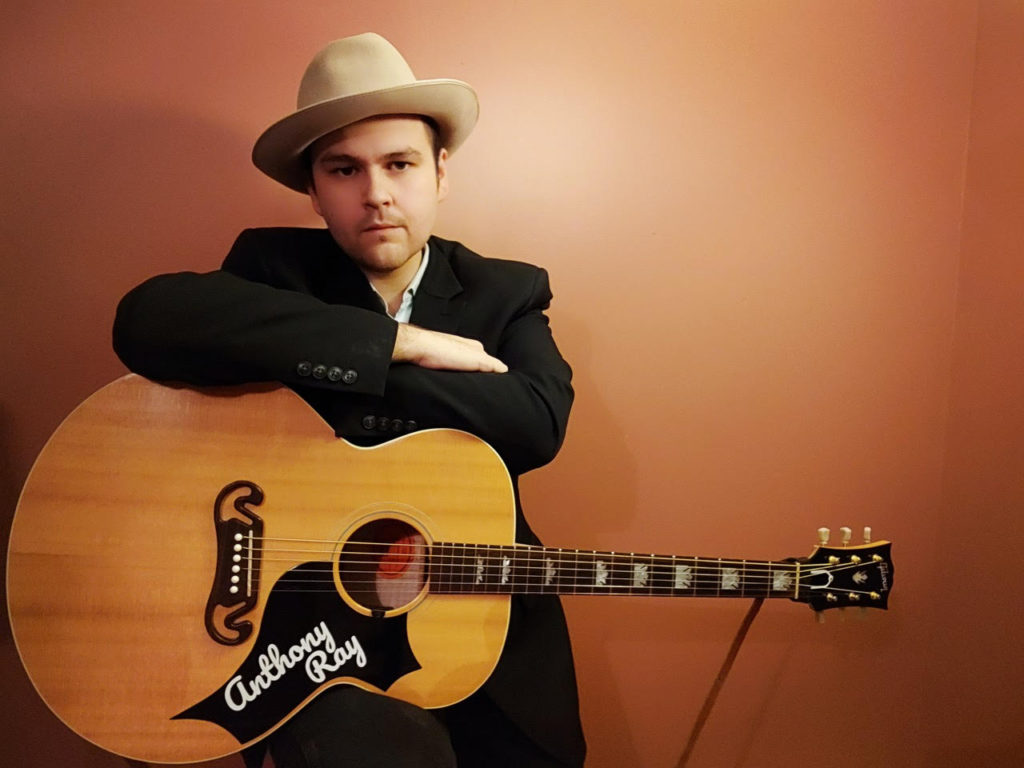 Anthony Ray Wright, musician in hat with guitar