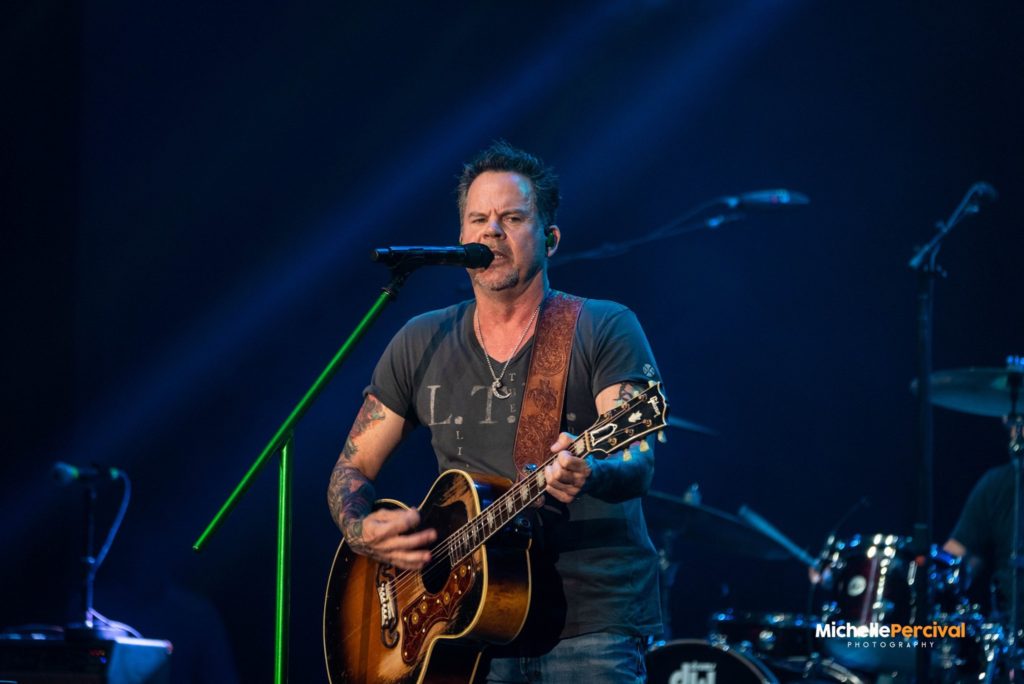 Gary Allan playing guitar on stage