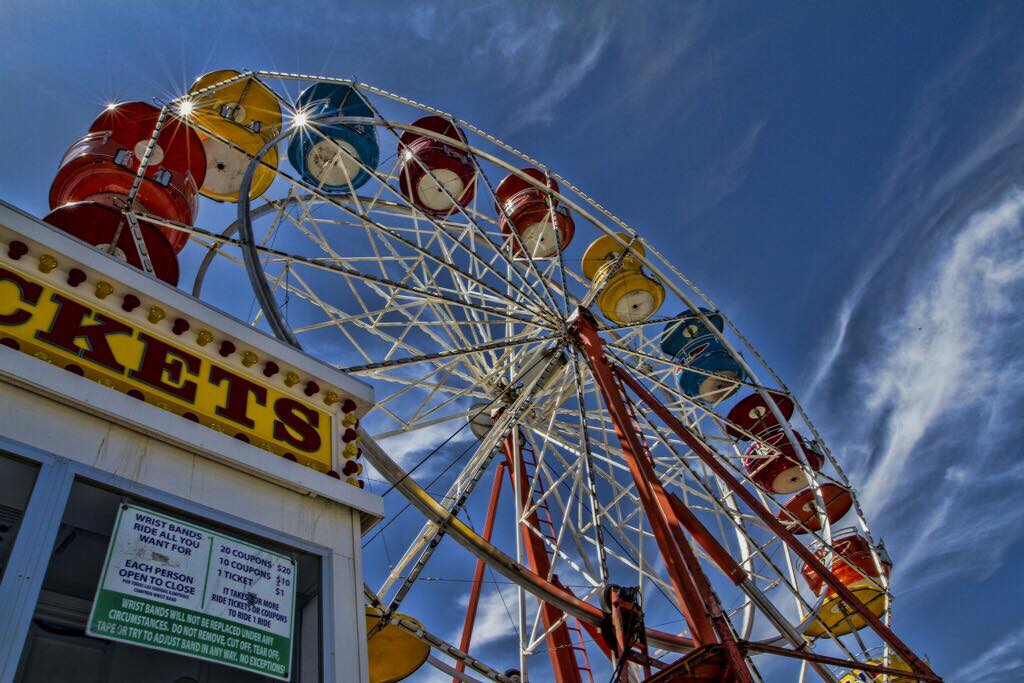 Wright's Amusements carnival ticket booth and ferris wheel.