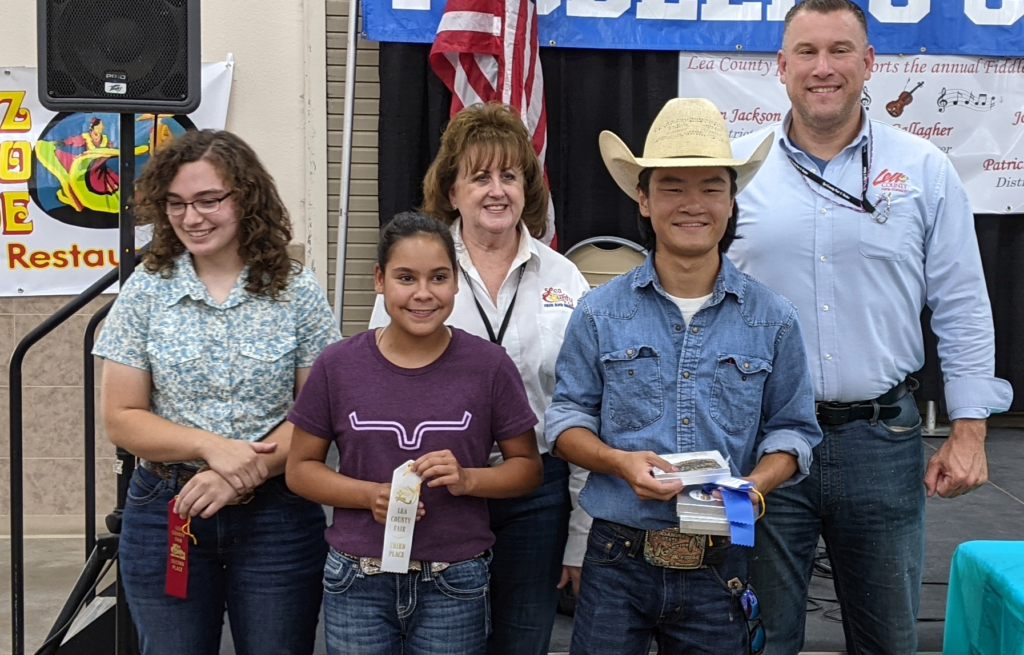 Nathan Pedno, Jade Thronberry and Madison López receiving award for Fiddler's Contest