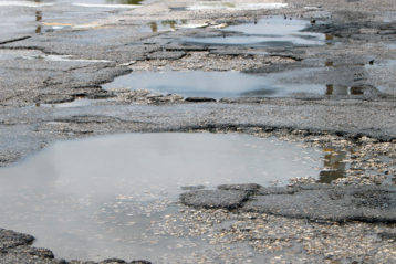 Pot holes with water on Main Street in Lovington, NM