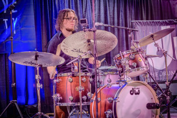 Wayne Salzmann playing drums on stage