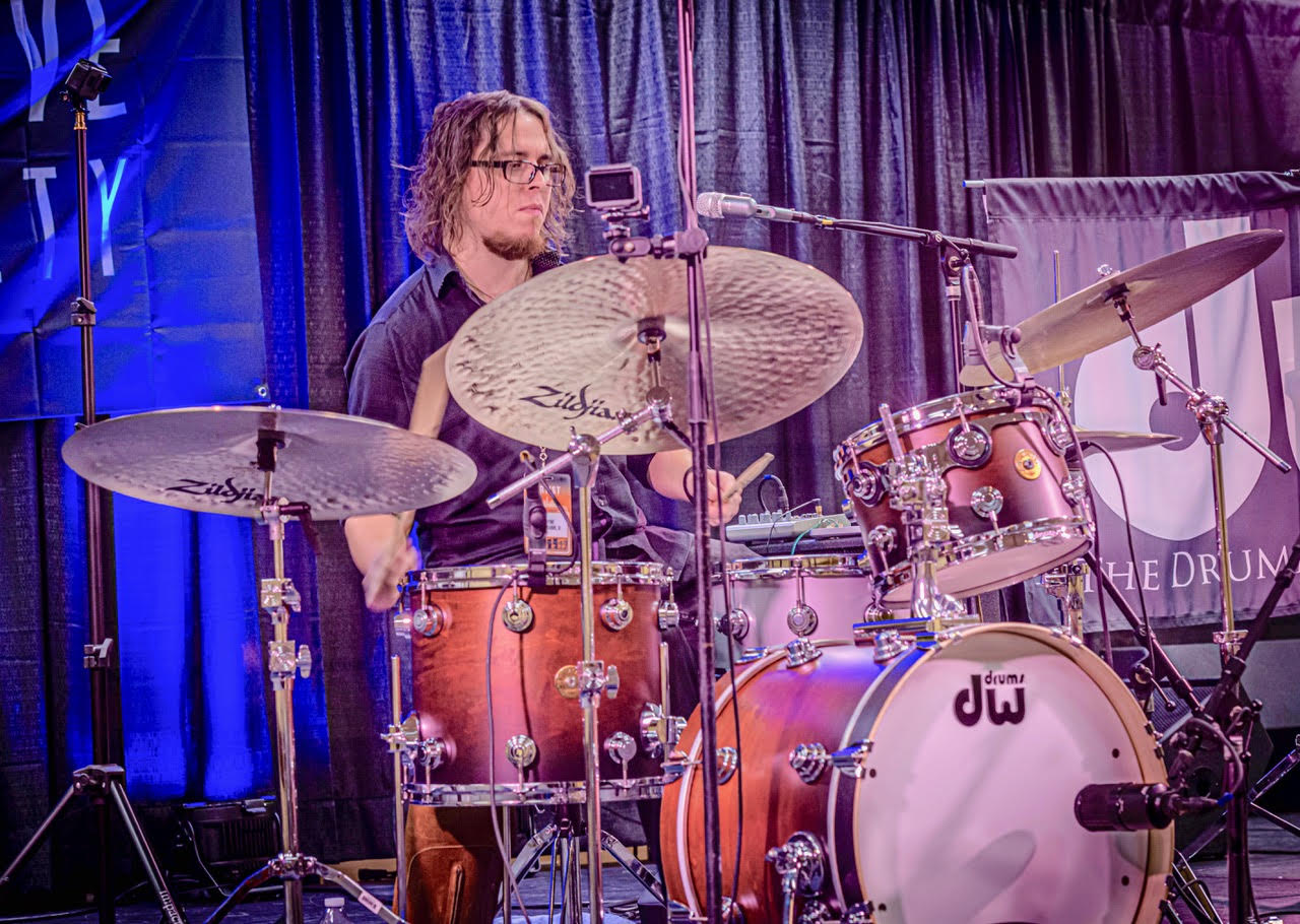 Wayne Salzmann playing drums on stage