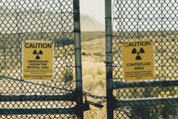 Nuclear radiation caution signs on fence gate
